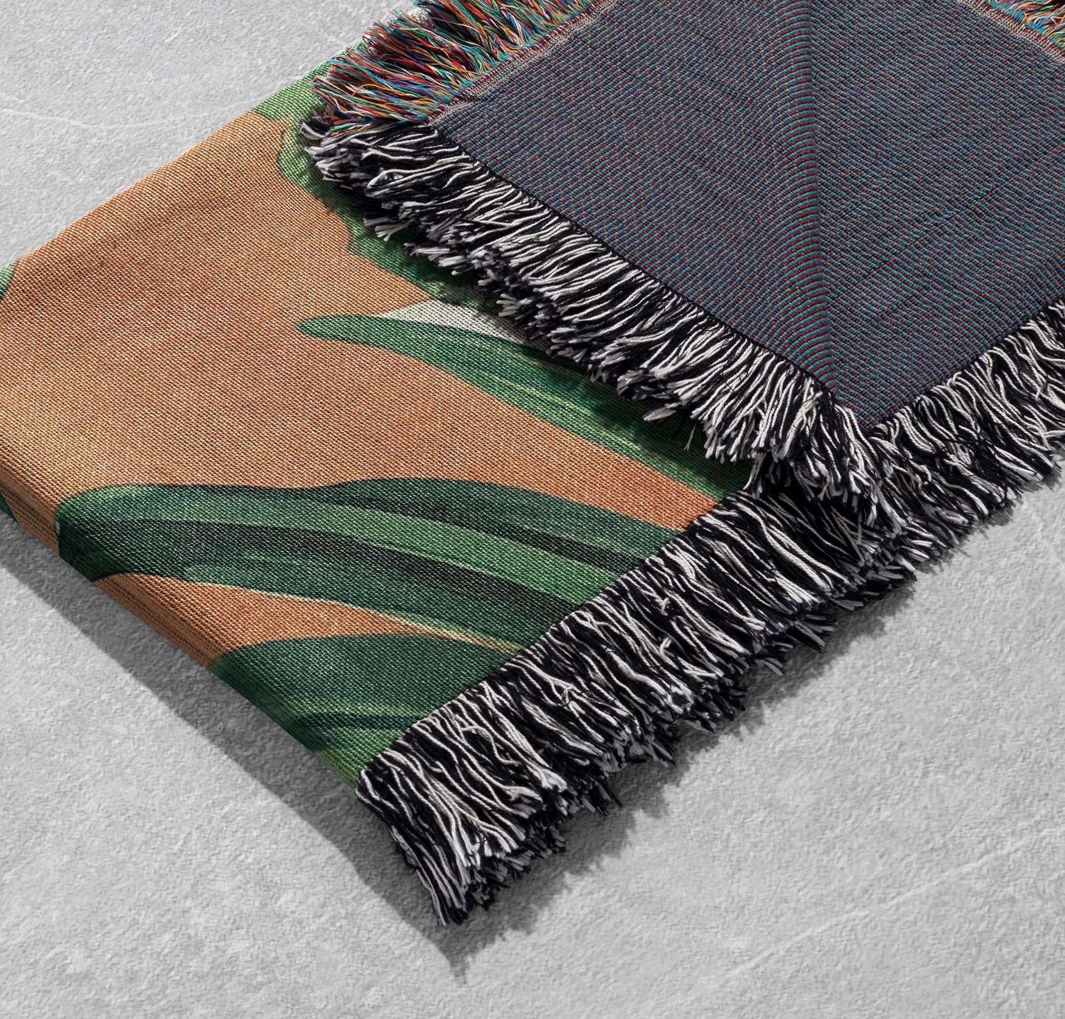 tropical palm leaf woven blanket green foliage on warm earthy background with fringed edges cottagecore tapestry